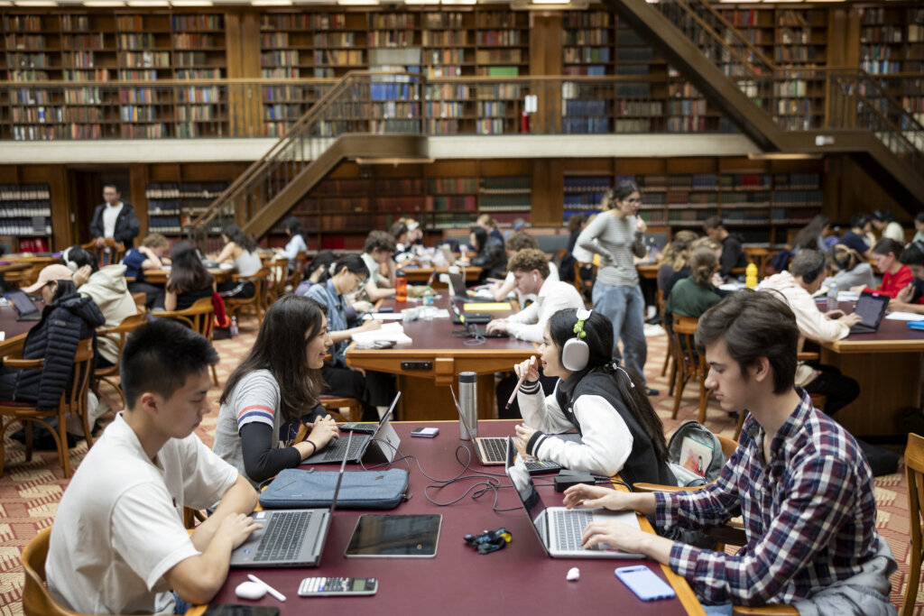 people sitting at desks in the Mitchell Library Reading Room